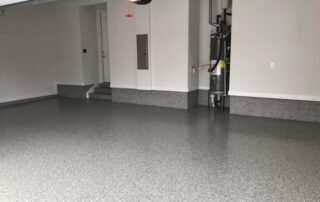 This image shows a garage floor with epoxy flake flooring.